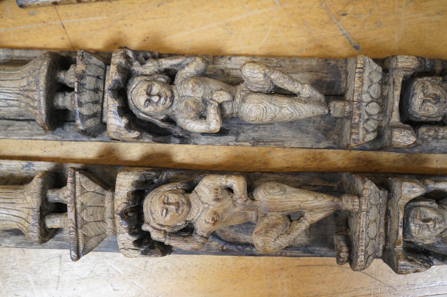 A pair of 19th century Indian carved wood figural pilasters - 74cm long